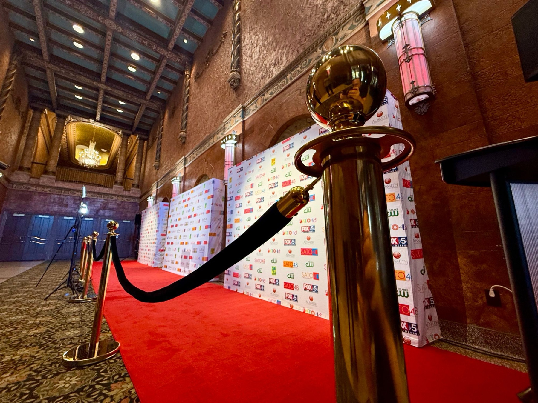 Red carpet, velvet ropes and SATO48 sponsor backdrops set up in a historic theater lobby for the awards